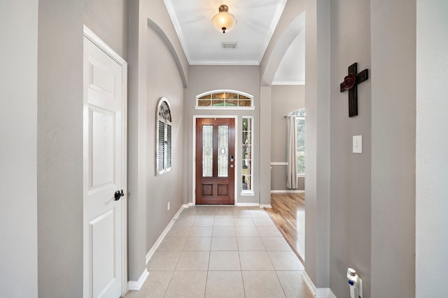 tiled entryway with crown molding