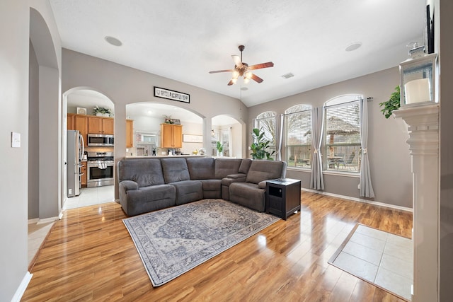 living room featuring ceiling fan and light hardwood / wood-style flooring