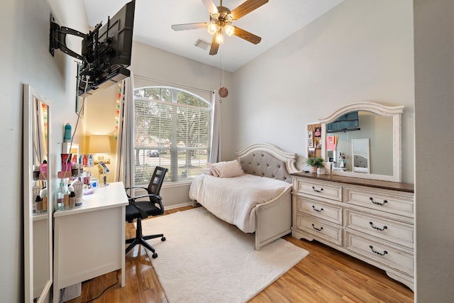 bedroom featuring ceiling fan, lofted ceiling, and light hardwood / wood-style floors