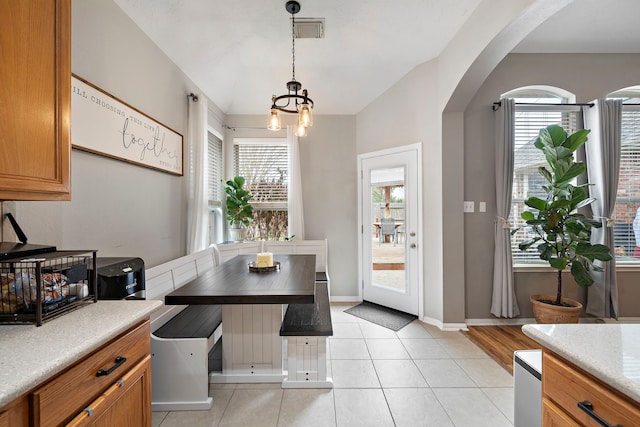 tiled dining area featuring a healthy amount of sunlight