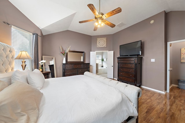 bedroom with hardwood / wood-style flooring, vaulted ceiling, ensuite bath, and ceiling fan