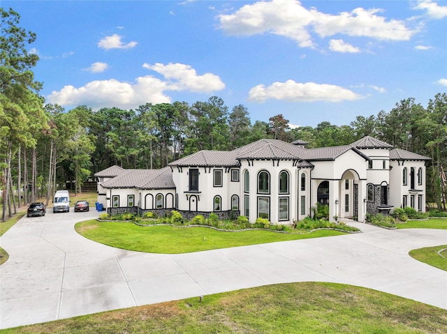 mediterranean / spanish-style house featuring a front yard