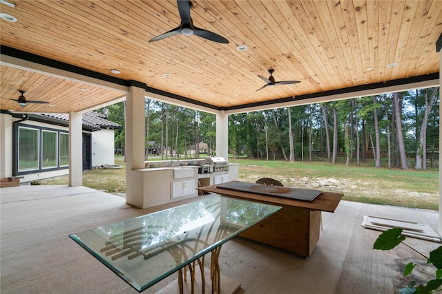 view of patio featuring grilling area, ceiling fan, and an outdoor kitchen