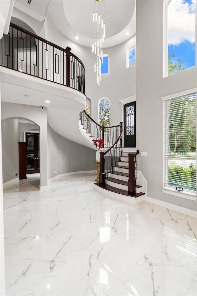 entrance foyer featuring an inviting chandelier and a towering ceiling