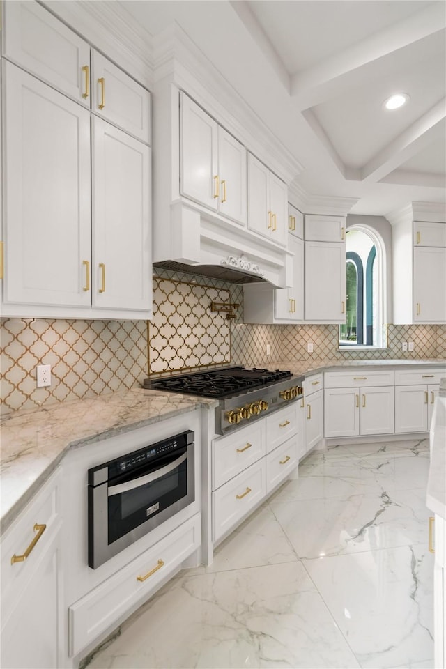 kitchen with stainless steel gas stovetop and white cabinetry