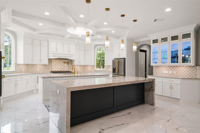 kitchen featuring hanging light fixtures, white cabinetry, a large island, and high end refrigerator