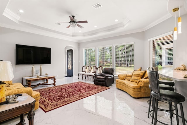 living room featuring crown molding and a raised ceiling