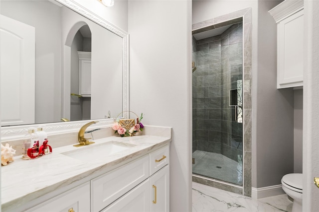 bathroom with an enclosed shower, vanity, and toilet