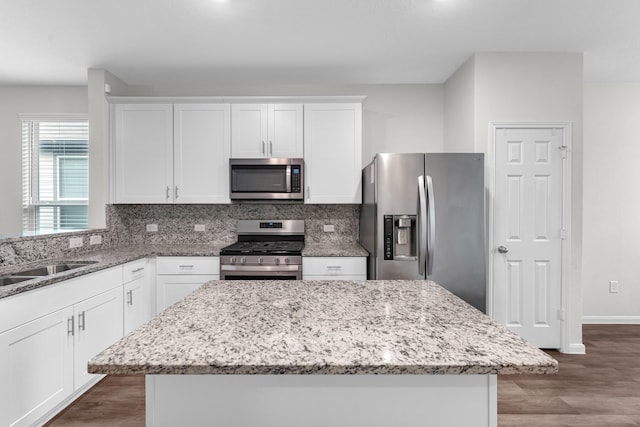 kitchen featuring stainless steel appliances, white cabinets, and a kitchen island