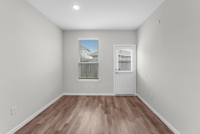 empty room with light hardwood / wood-style flooring