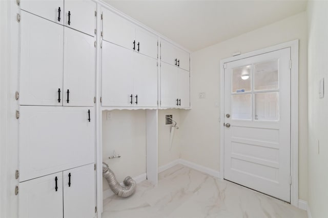 clothes washing area with cabinets, hookup for an electric dryer, and hookup for a washing machine