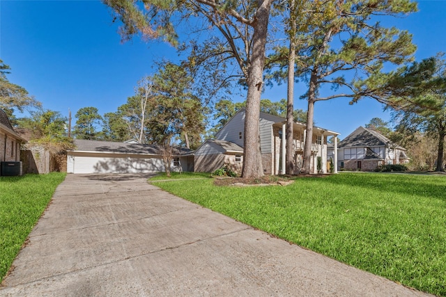 view of front of house with cooling unit and a front lawn