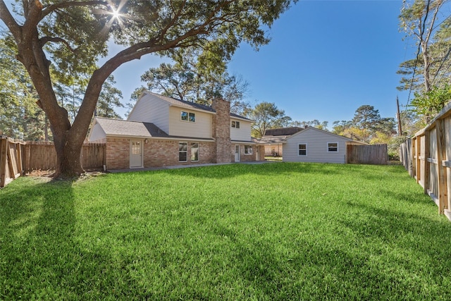 back of house with a yard