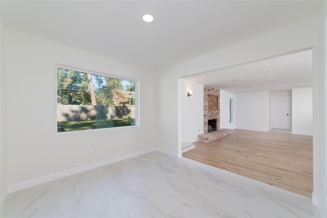 unfurnished living room with a fireplace