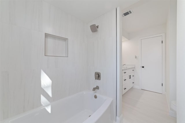 full bathroom featuring vanity, toilet, and tiled shower / bath combo