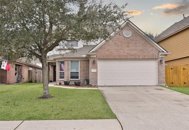 view of front facade with a garage and a lawn