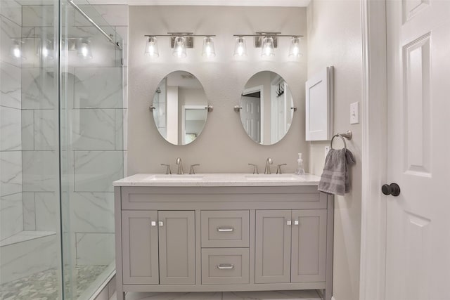 bathroom featuring vanity and tiled shower