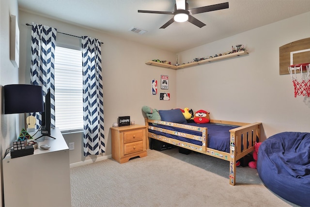 bedroom with ceiling fan, light colored carpet, and multiple windows