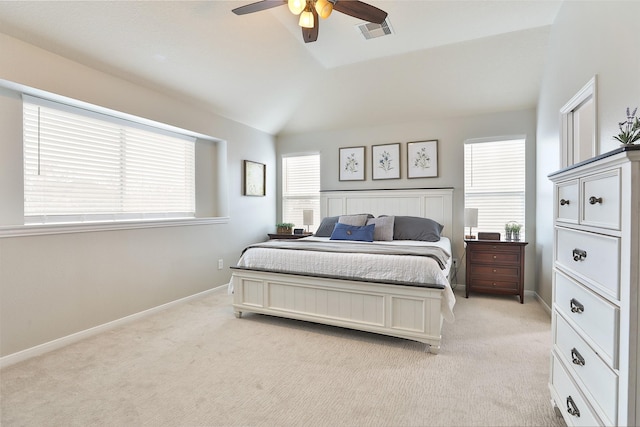 bedroom with lofted ceiling, multiple windows, and light colored carpet