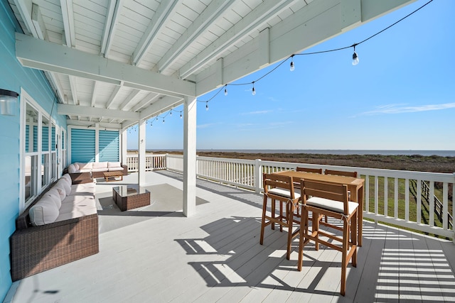 wooden terrace with an outdoor living space