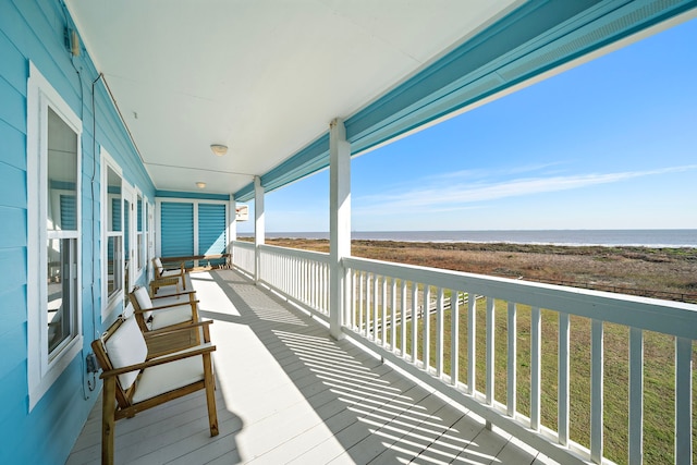 balcony featuring a water view and a porch