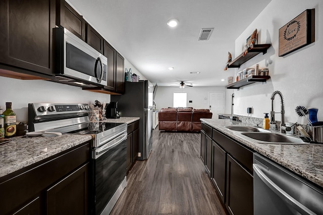 kitchen featuring sink, ceiling fan, dark brown cabinetry, stainless steel appliances, and dark wood-type flooring