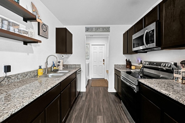 kitchen with dark brown cabinetry, sink, dark hardwood / wood-style floors, stainless steel appliances, and light stone countertops