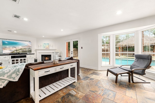 living room with a brick fireplace