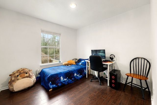 bedroom with dark hardwood / wood-style floors