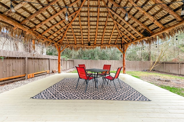 wooden terrace featuring a gazebo