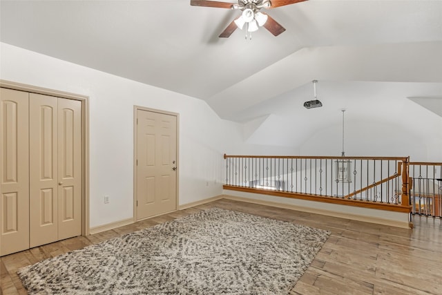 additional living space with vaulted ceiling, ceiling fan, and light wood-type flooring