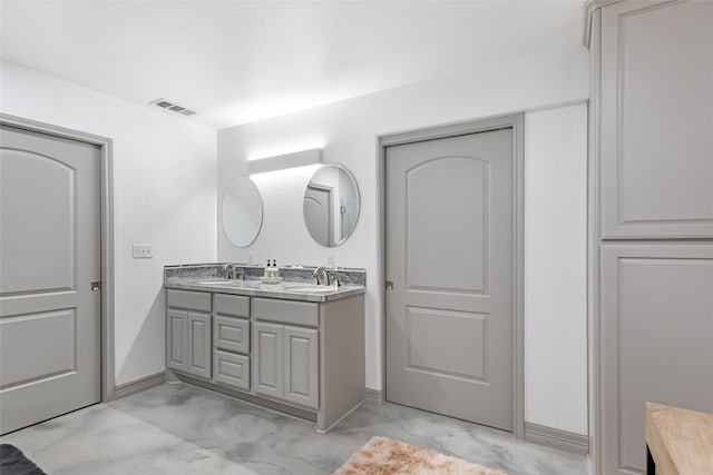 bathroom with concrete flooring and vanity