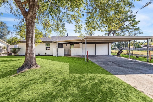 ranch-style home featuring a garage and a front yard