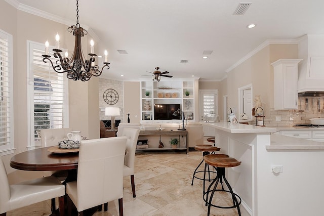 dining space featuring ceiling fan, ornamental molding, and sink