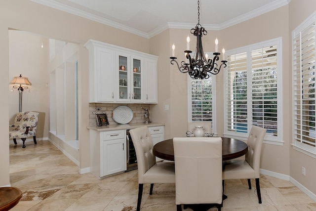 dining space featuring an inviting chandelier, crown molding, and beverage cooler