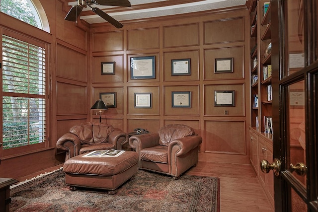 living area featuring ceiling fan, a healthy amount of sunlight, and light hardwood / wood-style floors