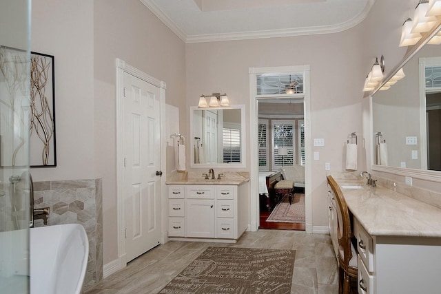 bathroom with vanity, a washtub, and crown molding