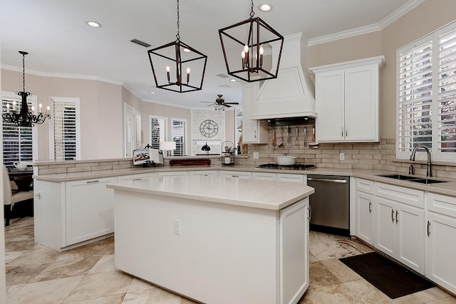 kitchen with appliances with stainless steel finishes, a kitchen island, sink, and kitchen peninsula