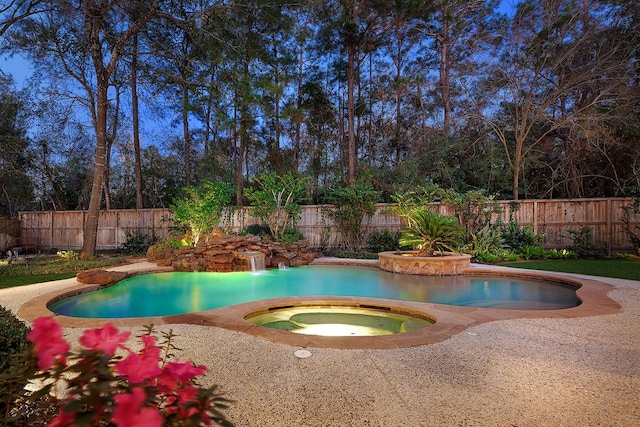 view of swimming pool with an in ground hot tub