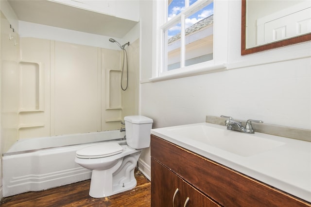 full bathroom with hardwood / wood-style flooring, toilet, vanity, and shower / bathing tub combination