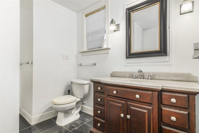 bathroom with vanity, tile patterned floors, and toilet