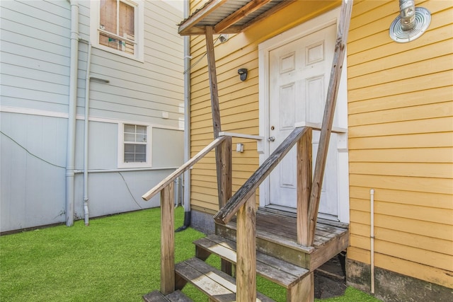 doorway to property with a yard