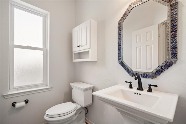 bathroom featuring toilet and sink