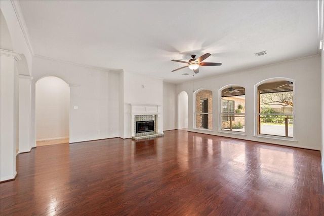 unfurnished living room featuring ornamental molding, dark hardwood / wood-style floors, and ceiling fan