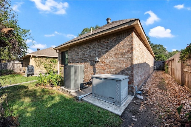 back of house featuring cooling unit and a lawn