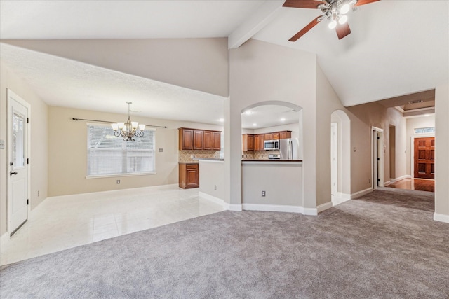 unfurnished living room featuring beamed ceiling, ceiling fan with notable chandelier, light carpet, and high vaulted ceiling