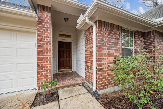 doorway to property with a garage