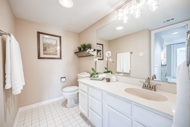 bathroom with vanity, tile patterned floors, and toilet