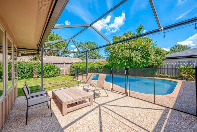 view of swimming pool featuring a lanai, a patio area, and a lawn