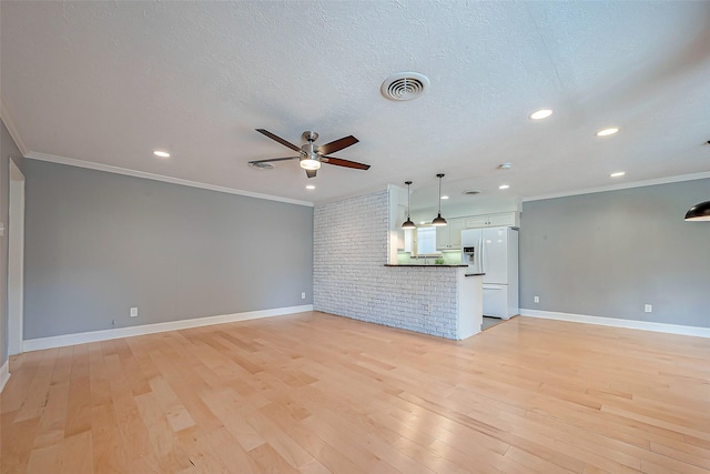 unfurnished living room featuring crown molding, a textured ceiling, and light hardwood / wood-style flooring